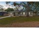 Charming single-story home features a front porch, well-maintained lawn, and mature shade tree at 1709 W Dempsey Ave, Tampa, FL 33603