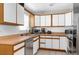 Functional kitchen featuring white cabinets, stainless steel appliances, and ample counter space at 1709 W Dempsey Ave, Tampa, FL 33603