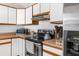 Functional kitchen featuring white cabinets, stainless steel appliances, and ample counter space at 1709 W Dempsey Ave, Tampa, FL 33603