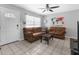 Cozy living room with tile flooring, neutral paint, ceiling fan, and comfortable seating at 1709 W Dempsey Ave, Tampa, FL 33603