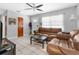 Cozy living room with tile flooring, neutral paint, ceiling fan, and comfortable seating at 1709 W Dempsey Ave, Tampa, FL 33603