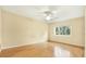 Spacious bedroom with hardwood floors, a ceiling fan, and a bright window at 3038 Eastland Blvd # F103, Clearwater, FL 33761