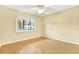 Empty bedroom with hardwood floors, a ceiling fan, and a window at 3038 Eastland Blvd # F103, Clearwater, FL 33761