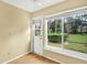 Bedroom with natural light through windows and an exterior exit door at 3038 Eastland Blvd # F103, Clearwater, FL 33761