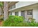 Condominium entrance framed by lush landscaping, offering a welcoming approach to the unit at 3038 Eastland Blvd # F103, Clearwater, FL 33761