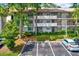 Exterior view of the home showing parking spaces and the exterior design at 3038 Eastland Blvd # F103, Clearwater, FL 33761