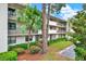 Condominium exterior with well-maintained landscaping and multiple stories of residences, and covered parking at 3038 Eastland Blvd # F103, Clearwater, FL 33761