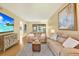 Cozy living room featuring neutral decor, comfortable seating, and a modern entertainment setup at 3038 Eastland Blvd # F103, Clearwater, FL 33761