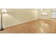 Empty living room with light walls, wood floor, fan and natural light at 3038 Eastland Blvd # F103, Clearwater, FL 33761
