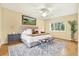Well-lit main bedroom featuring a plush bed, decorative rug, and a serene ambiance for relaxation at 3038 Eastland Blvd # F103, Clearwater, FL 33761