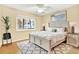 Comfortable bedroom with bed, side tables, and a patterned rug at 3038 Eastland Blvd # F103, Clearwater, FL 33761
