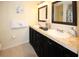 Bathroom features dual sinks, dark cabinets, and modern fixtures and decor at 3526 Overland Dr, Holiday, FL 34691