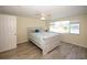 Bright bedroom features wood-look floors, a ceiling fan, and a large window with lovely outdoor views at 3526 Overland Dr, Holiday, FL 34691