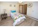 Bedroom featuring wood-look floors and a bright, stylish comforter and easy access to other rooms at 3526 Overland Dr, Holiday, FL 34691
