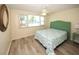 This is a comfortably decorated bedroom with wood-look flooring, a ceiling fan and good natural light at 3526 Overland Dr, Holiday, FL 34691