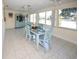 Sunlit dining area featuring lake views and a charming blue accent cabinet at 3526 Overland Dr, Holiday, FL 34691