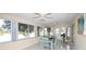 Dining area with large windows and scenic lake views, flooded with natural light at 3526 Overland Dr, Holiday, FL 34691