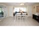 Bright dining area with tiled floors, seating, and decor at 3526 Overland Dr, Holiday, FL 34691