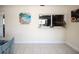 Partially furnished dining area with view to the kitchen; features colorful art and neutral walls at 3526 Overland Dr, Holiday, FL 34691
