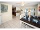 Bright dining area with white tile floors, table set for a meal, and outdoor views at 3526 Overland Dr, Holiday, FL 34691