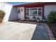 Charming front entrance with colorful flowerpots, red trim, and well-maintained landscaping, offering curb appeal at 3526 Overland Dr, Holiday, FL 34691