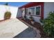 Charming front entrance with colorful flowerpots, red trim, and well-maintained landscaping, offering curb appeal at 3526 Overland Dr, Holiday, FL 34691