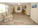 Inviting living room with wood-look floors, ceiling fan, and comfortable armchair at 3526 Overland Dr, Holiday, FL 34691