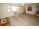 Inviting living room with wood-look floors, ceiling fan, and comfortable armchair at 3526 Overland Dr, Holiday, FL 34691