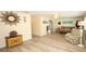Bright living room featuring wood-look tile flooring, neutral walls, and comfortable seating area at 3526 Overland Dr, Holiday, FL 34691