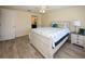 Cozy main bedroom featuring wood-look tile flooring, neutral walls, and stylish furnishings at 3526 Overland Dr, Holiday, FL 34691