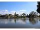 A scenic view of the lake and homes at 3526 Overland Dr, Holiday, FL 34691