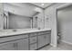 Bathroom featuring a double sink vanity with gray cabinets and white countertops and a large mirror at 4066 Cloud Hopper Way, Lutz, FL 33559