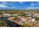 Aerial view of the waterfront property with a pool, boat dock, canal access and lush landscaping at 4115 Corn St, Port Charlotte, FL 33948