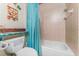 Cozy bathroom featuring a tub with shower and colorful decor on walls, adding a touch of personality at 4115 Corn St, Port Charlotte, FL 33948