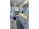 Bathroom featuring a single sink vanity with decorative mirror, a tiled floor and walk-in shower at 4115 Corn St, Port Charlotte, FL 33948