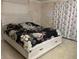 A well staged bedroom with a large platform bed and neutral tones at 4115 Corn St, Port Charlotte, FL 33948