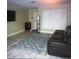 Relaxing living space with a modern rug, comfortable leather seating and bright natural light at 4115 Corn St, Port Charlotte, FL 33948