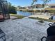 Outdoor patio area with pavers and a fire pit, leading to the waterfront and dock at 4115 Corn St, Port Charlotte, FL 33948