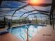Screened-in private pool surrounded by lush greenery, perfect for relaxation and outdoor enjoyment at 4115 Corn St, Port Charlotte, FL 33948