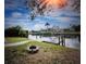 Scenic view of the waterfront with a dock and fire pit, perfect for outdoor living at 4115 Corn St, Port Charlotte, FL 33948