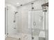 Modern shower with glass enclosure and marble-patterned tile for a spa-like experience at 4137 Seton Cir, Palm Harbor, FL 34683