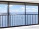 Balcony with views of the bay from sliding glass door and iron railing at 4620 Bay Blvd # 1154, Port Richey, FL 34668