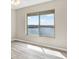 Bedroom with wood flooring and window overlooking water and trees at 4620 Bay Blvd # 1154, Port Richey, FL 34668