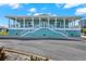 Exterior of a two-story, teal building with white railings and stairs leading to the entrance at 4620 Bay Blvd # 1154, Port Richey, FL 34668