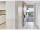 Condo foyer with tile flooring, coat closet, and a door to the outdoor patio with views of the bay at 4620 Bay Blvd # 1154, Port Richey, FL 34668