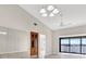 Bright living room featuring wood floors, mirrored wall, ceiling fan, and sliding door access to the lanai at 4620 Bay Blvd # 1154, Port Richey, FL 34668