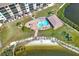 Aerial view of a community pool surrounded by a brick patio, lounge chairs, and a covered pavilion at 4620 Bay Blvd # 1154, Port Richey, FL 34668