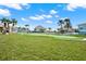 A putting green surrounded by grass and partially enclosed by fencing in the community at 4620 Bay Blvd # 1154, Port Richey, FL 34668