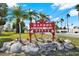 Community sign reads 'Harbor Isles' with palm trees and decorative rocks at 4620 Bay Blvd # 1154, Port Richey, FL 34668