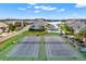 Aerial shot of community tennis courts with surrounding landscaping and nearby buildings at 4620 Bay Blvd # 1154, Port Richey, FL 34668